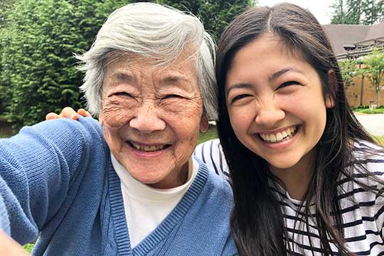 Grandmother and granddaughter smiling